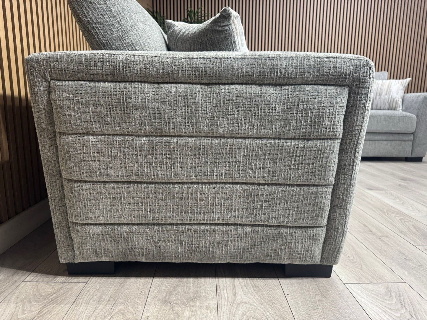 Gray upholstered sofa with cushions in a room setting