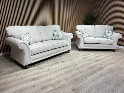 Gray sofa set with decorative pillows on a wooden floor and striped wall background